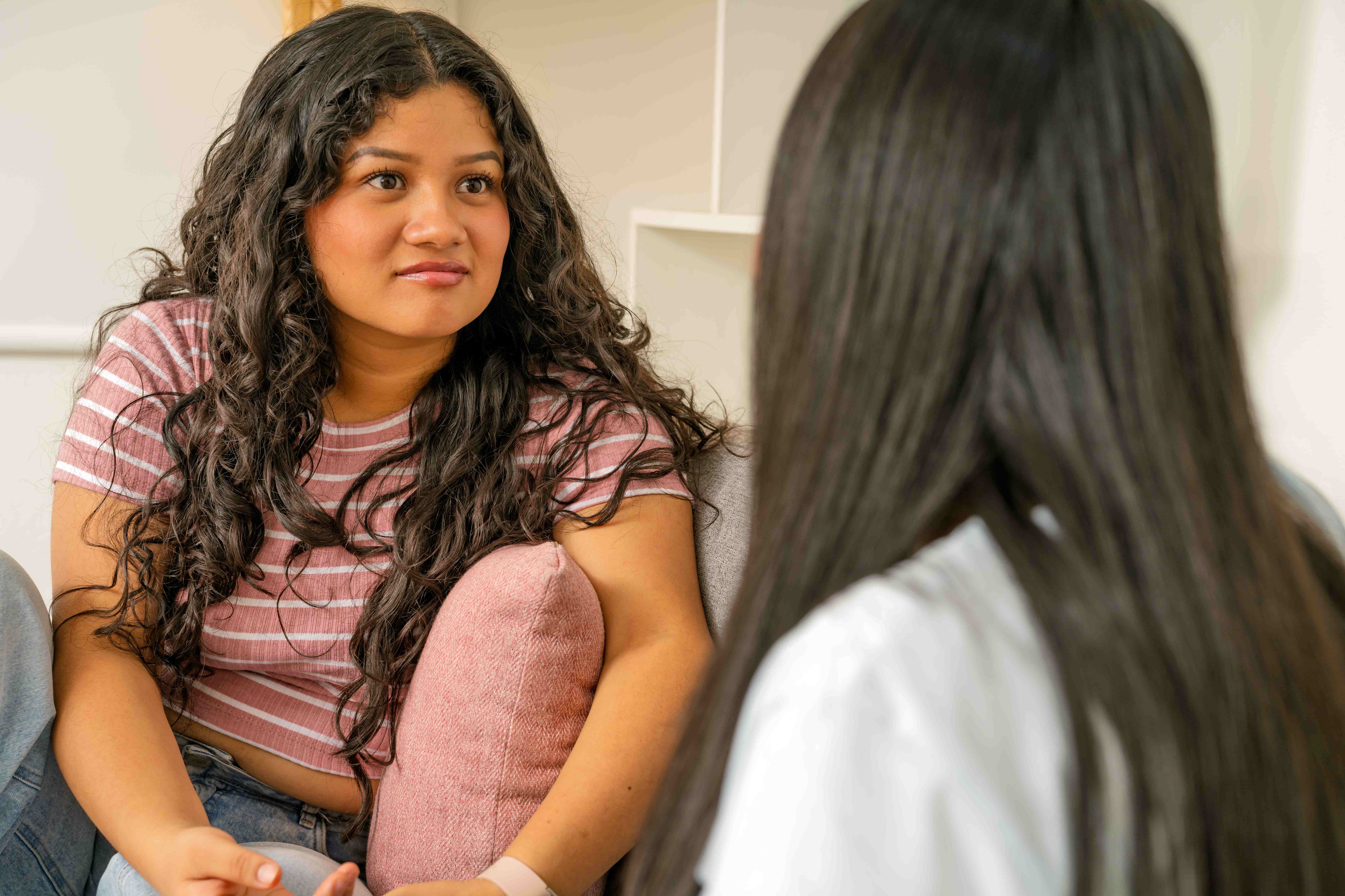 A young woman listening attentively during a one-on-one mentoring conversation