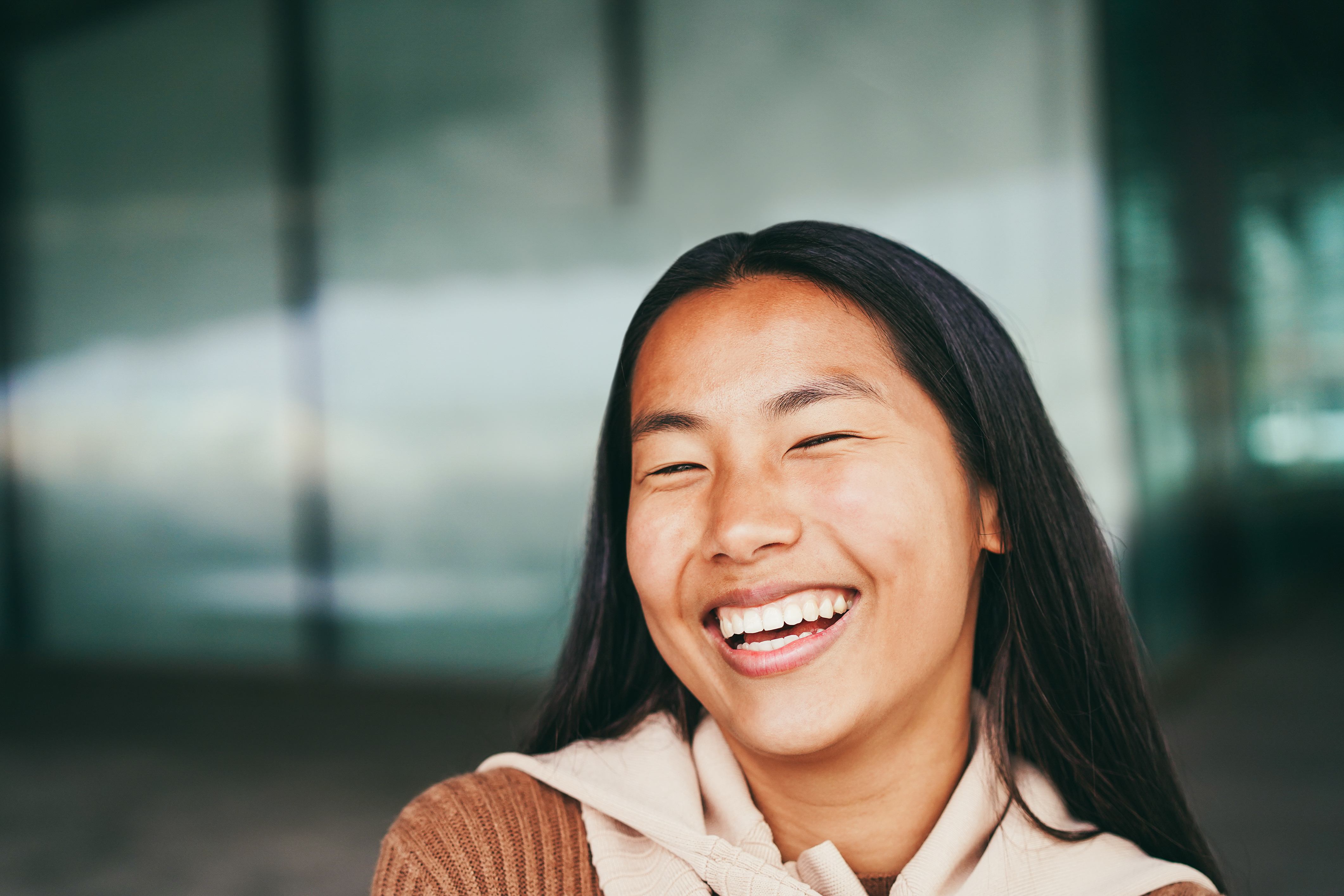 A young woman smiling, representing the students reached through Life Center education programs